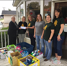 the staff senate presents the items from the green & gold hygiene drive to the Green & Gold Pantry