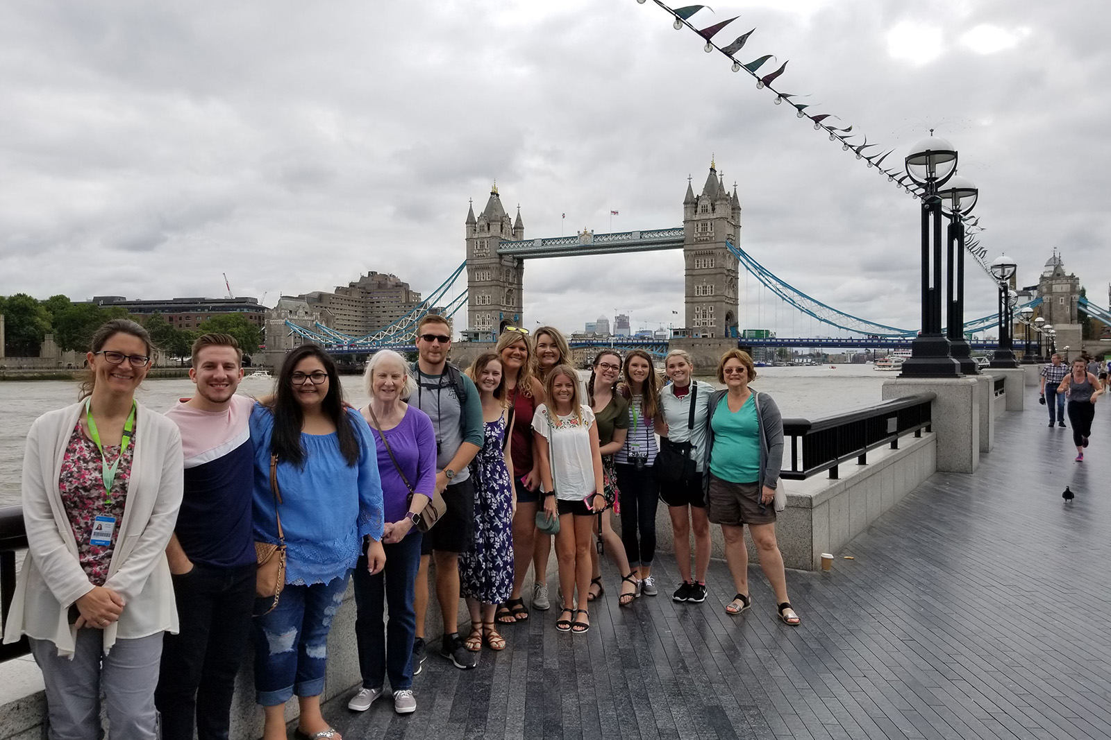 Students and faculty pause for a photo in front of the London Bridge