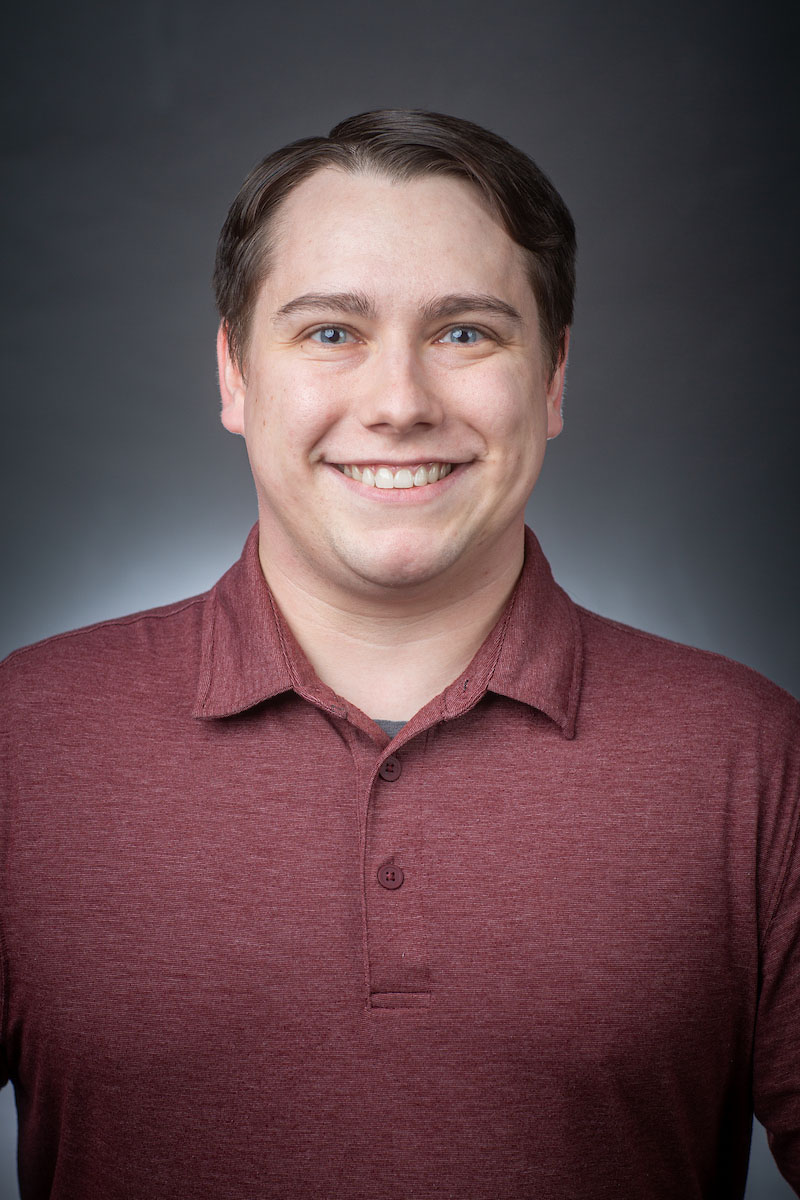 The head and torso of a smiling white man