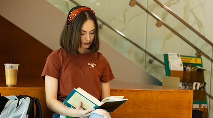 College Transfer Student studying on bench