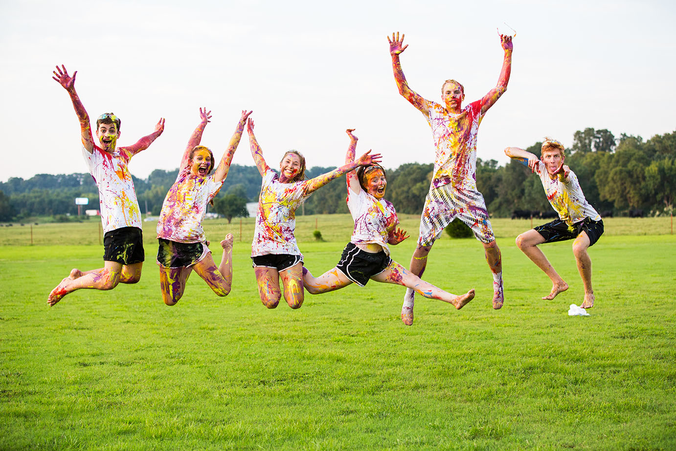 students jump for joy together after the SAB paint war