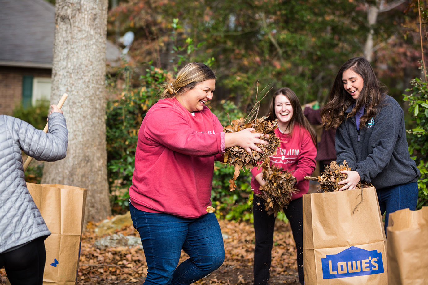 students cleaning up leaves