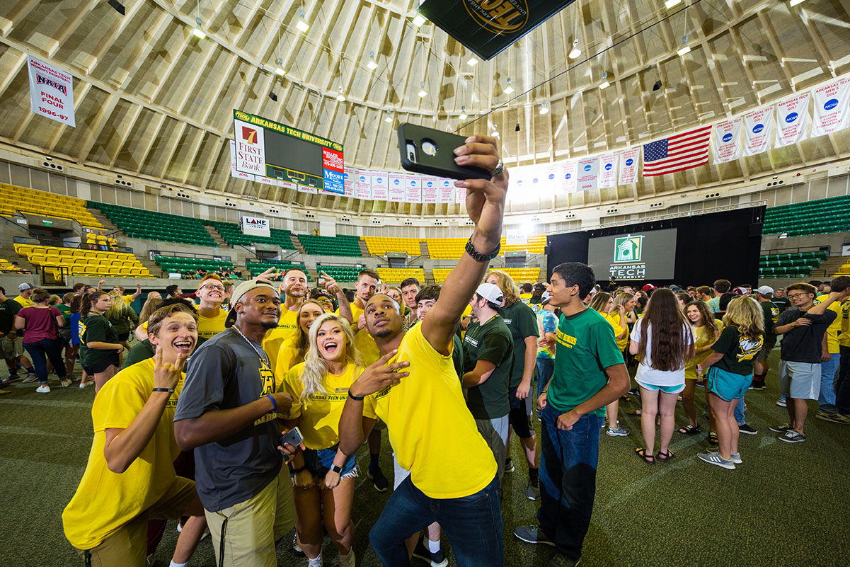a group of new student pose for a selfie at playfair