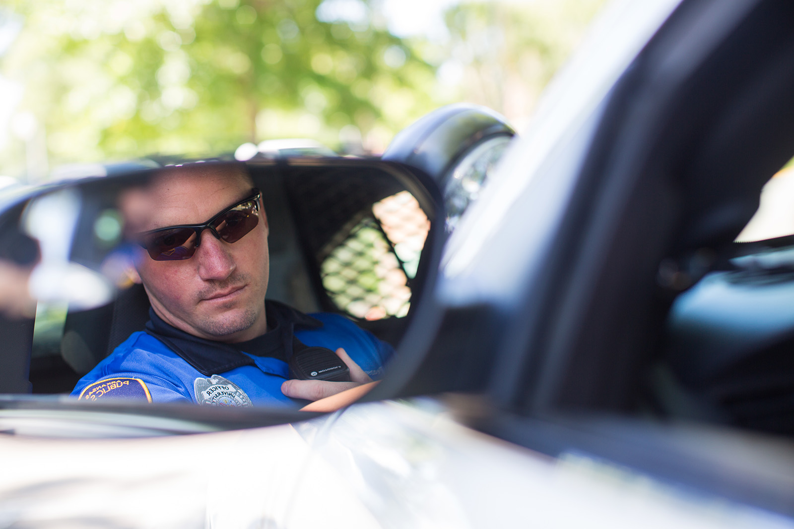 Officer Looking at rearview mirror