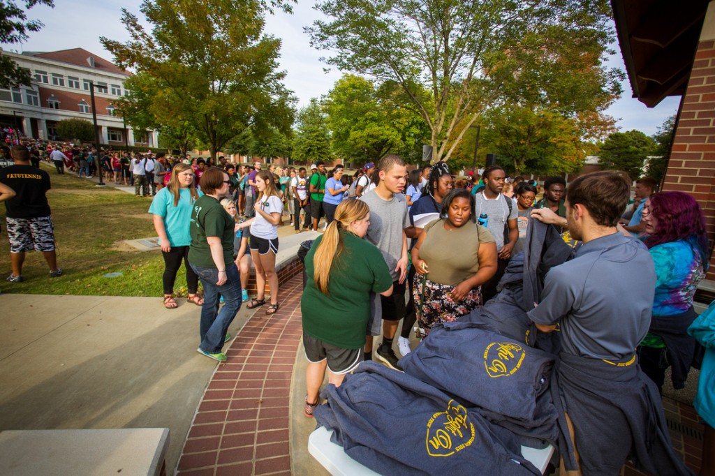 Photo of students passing out T-shirts