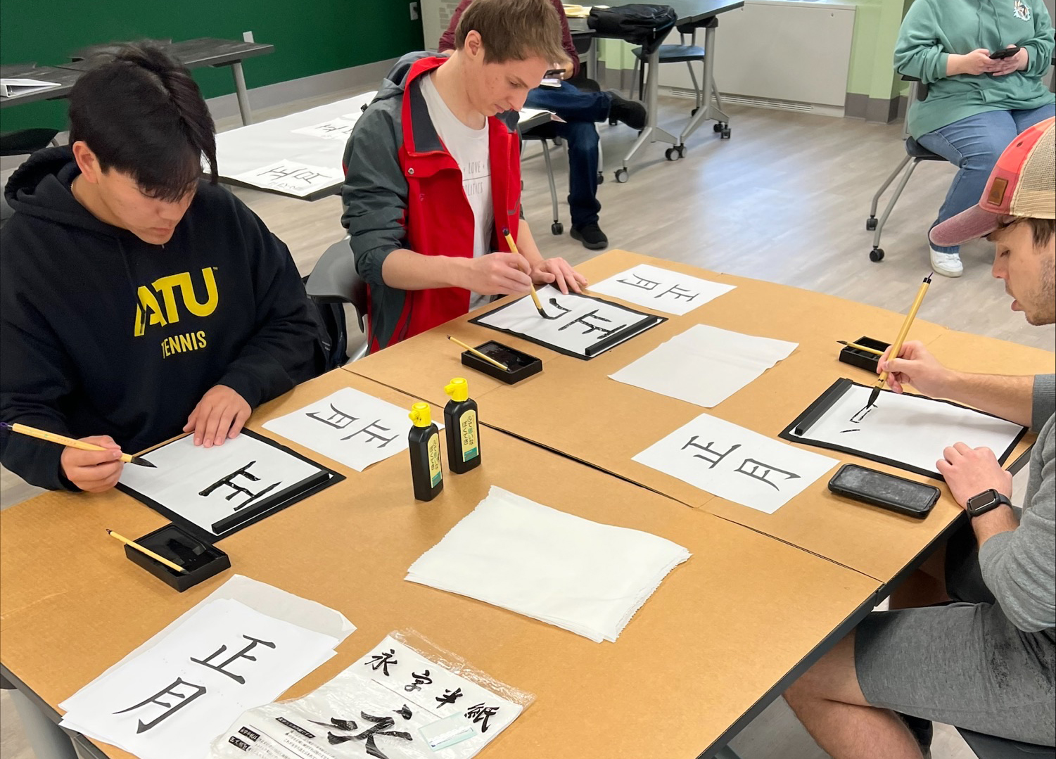 Students practicing Japanese writing